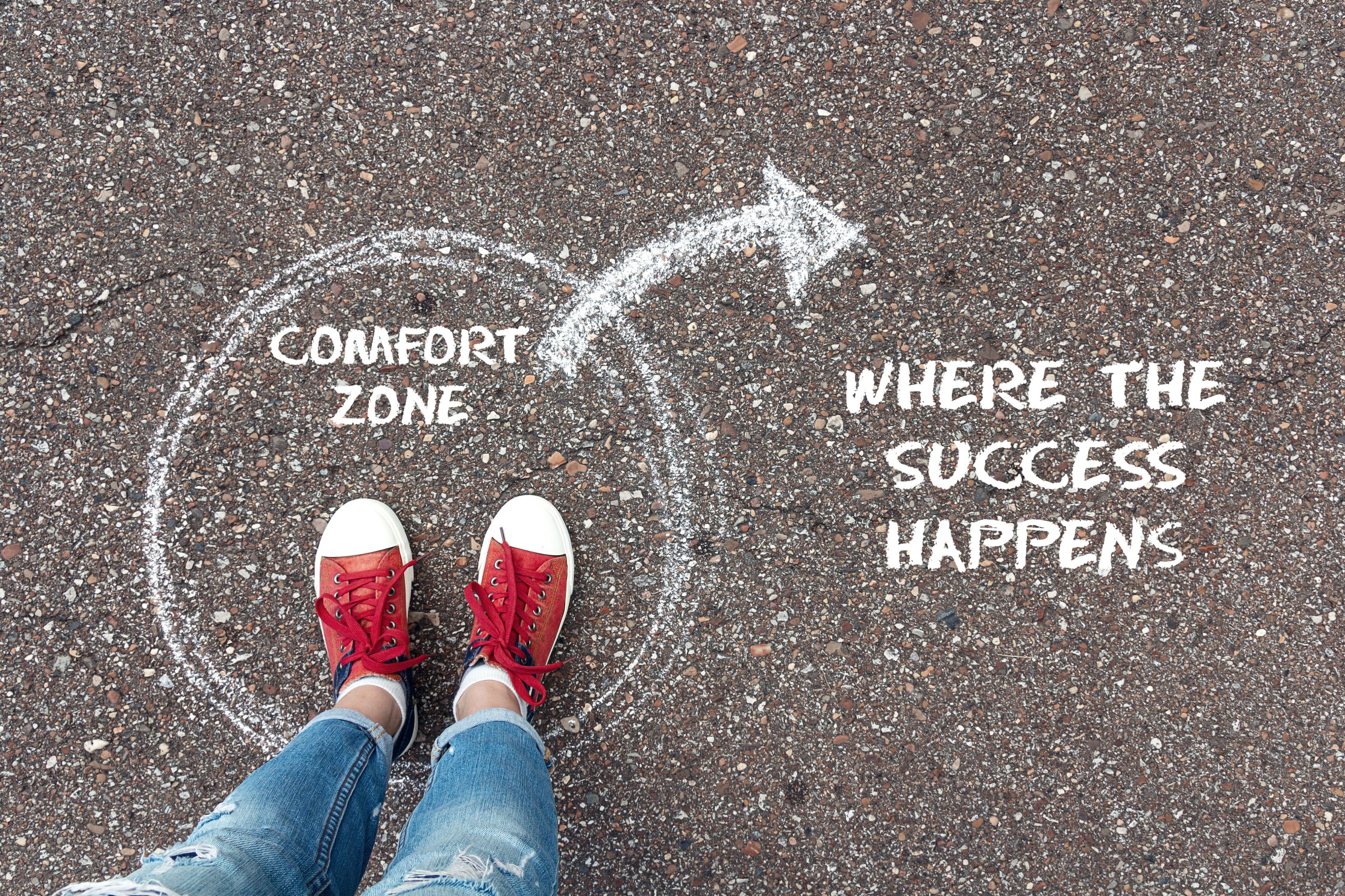 photo showing chalk circle with an arrow poionting outside the circle to indicate the comfort zone lies insisde the circle but success is outside that. 