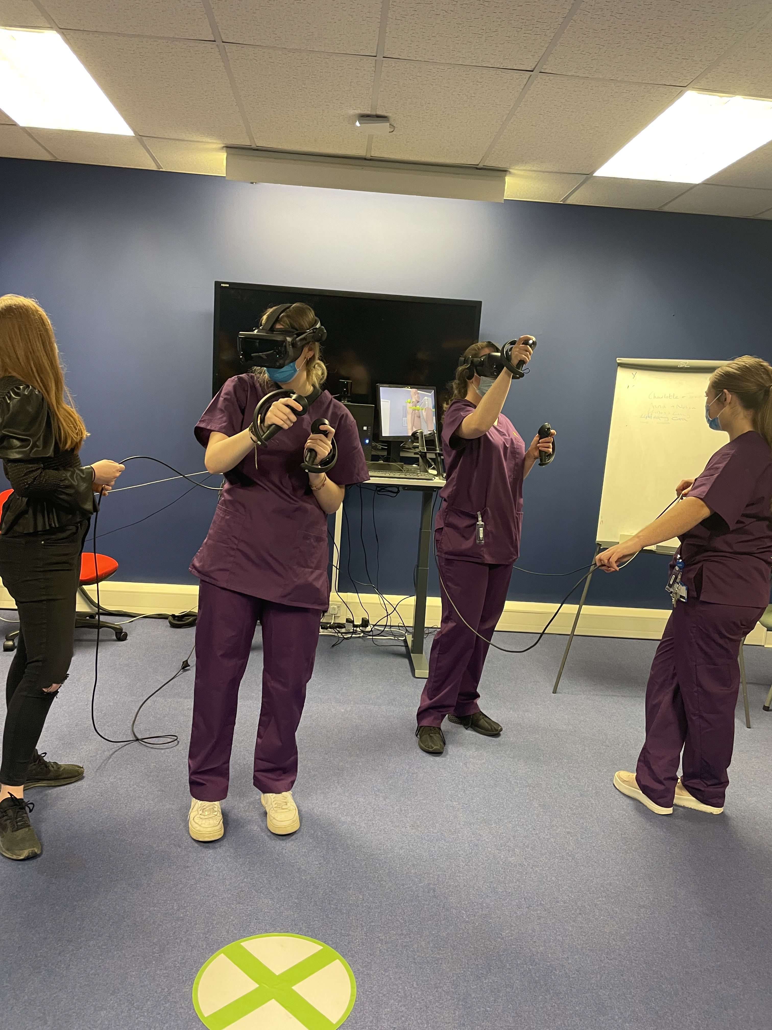 medical students in a room using Virtual Reality Headsets