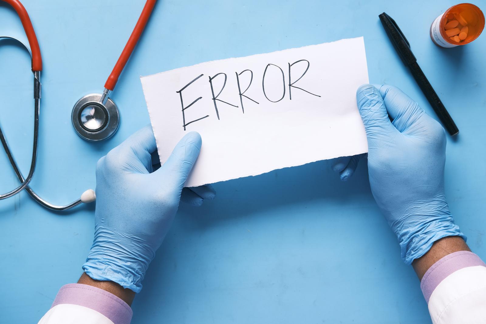 surgeon holding paper with error written on it